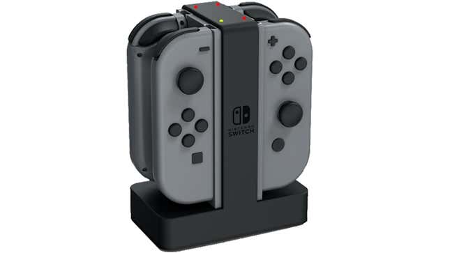 Two sets of gray Joy-Cons are shown charging on a dock.
