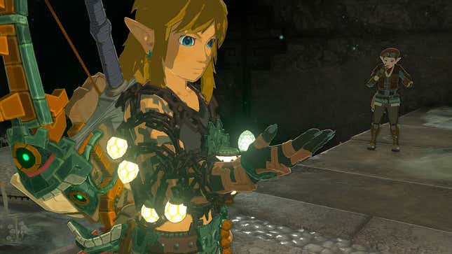 Link looks at his robo hand as it glows.