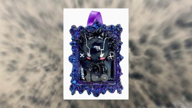 An image shows a black and purple clay art frame.